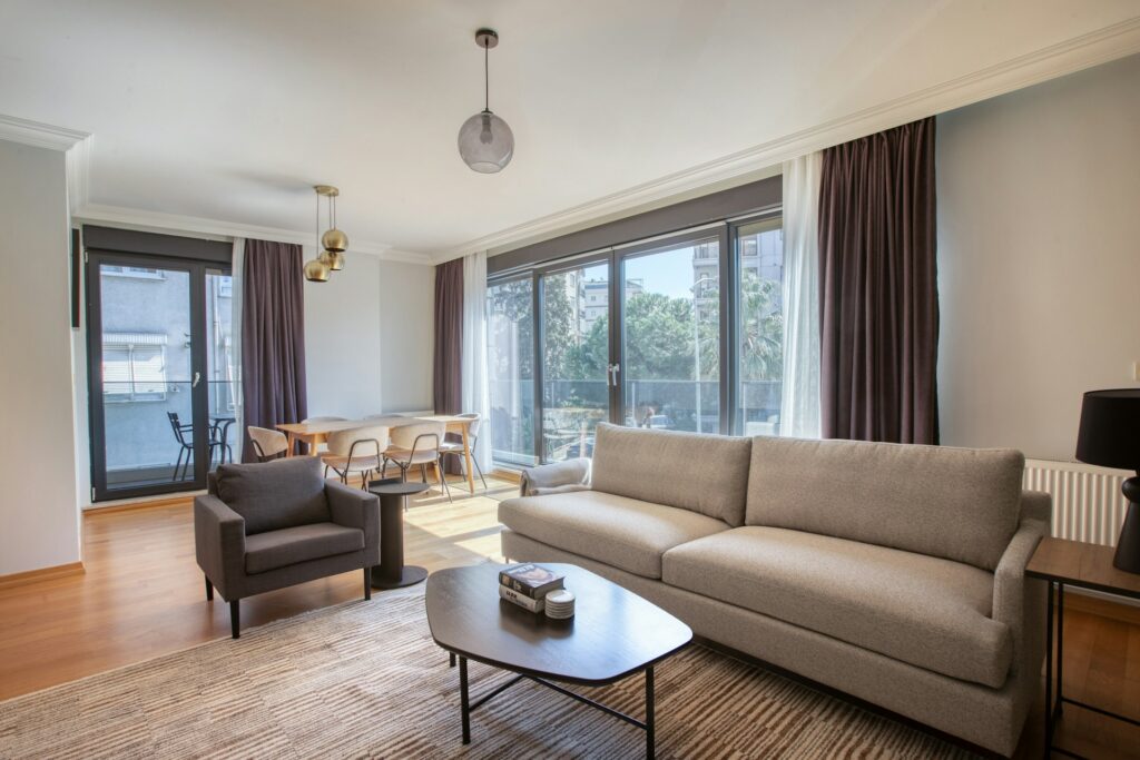 Professional real estate photography of bright living room with large windows